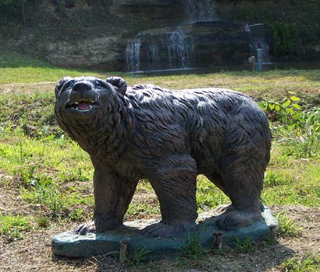 This bear stands in front of the falls at Rocky Falls Campground & RV Park.